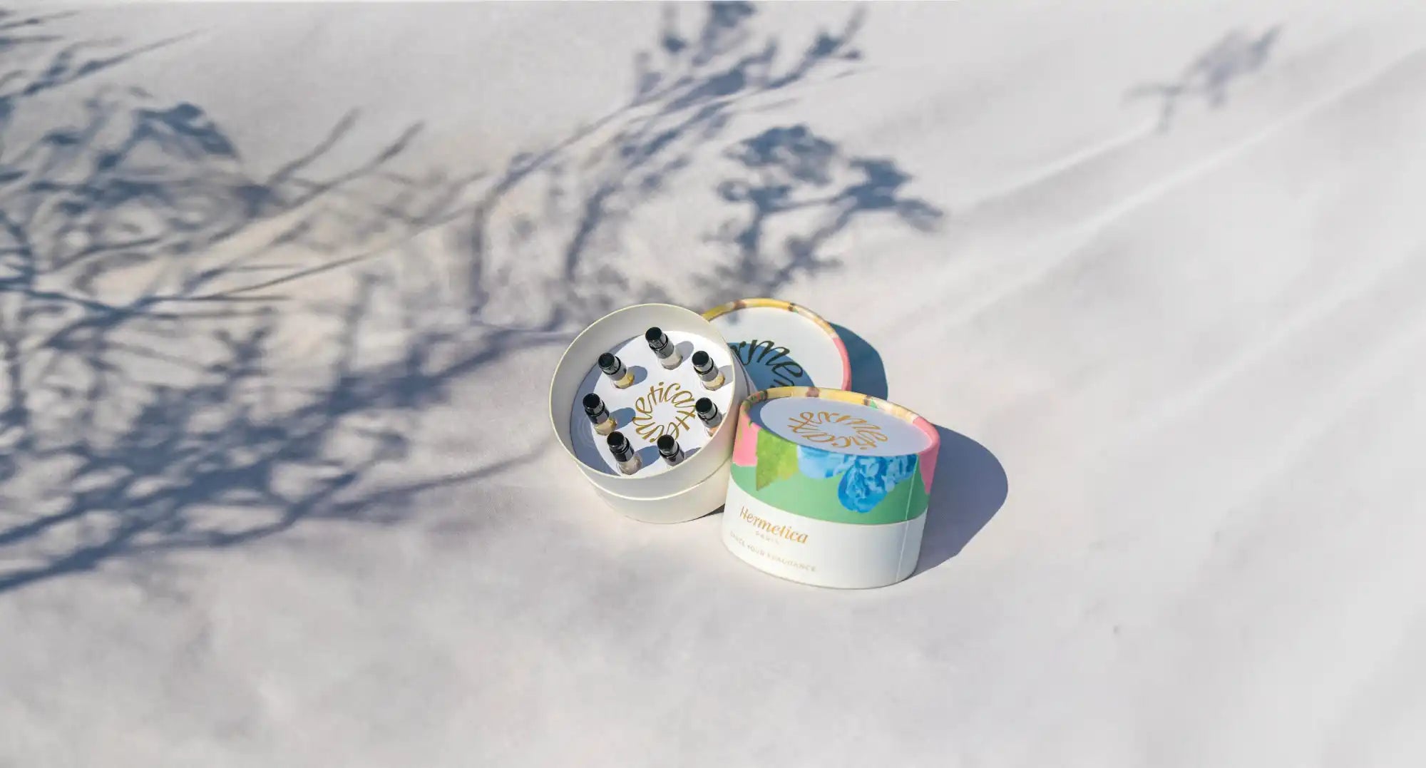 Metal herb grinder with colorful tie-dye design.
