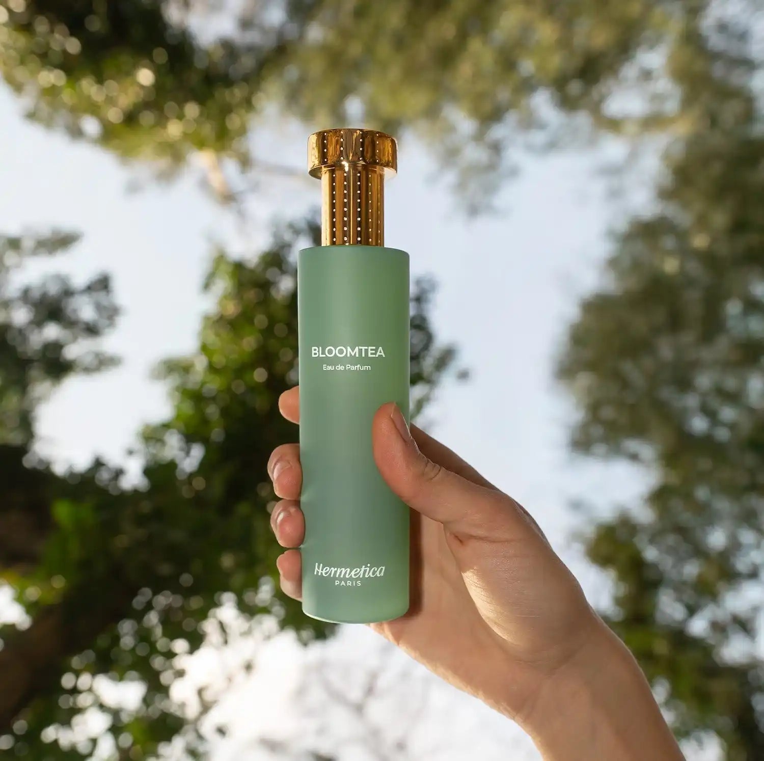 Green perfume bottle with gold cap.