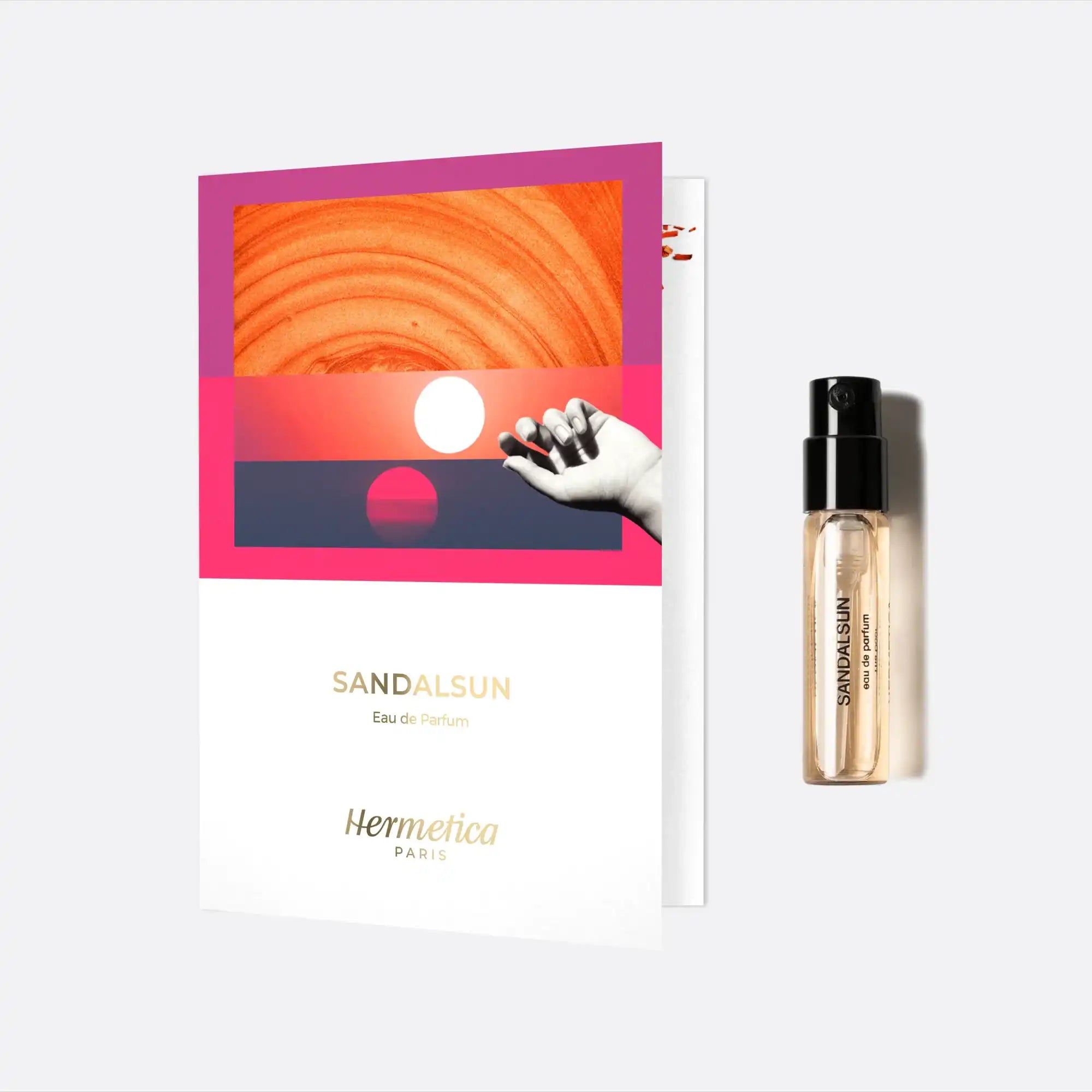 Perfume sample card with an orange and pink sunset design.