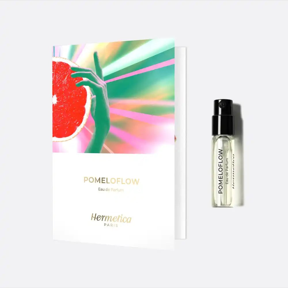 Perfume sample vial with a colorful promotional card featuring a grapefruit design.