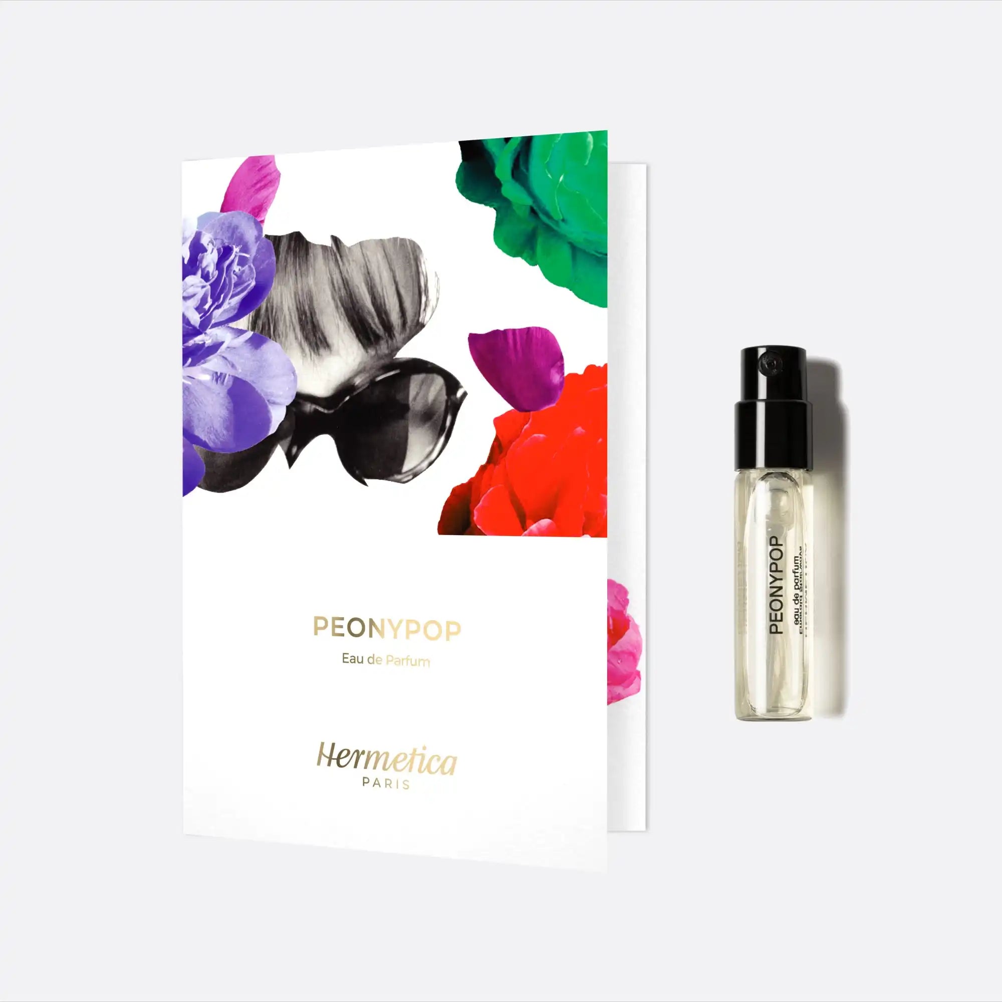 Perfume sample vial next to a floral-designed product card.